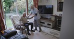 Nursing home, nurse and senior man in chair for healthcare, disability assistance and medical support. Living room, retirement and caregiver helping sick, disabled and elderly patient from couch
