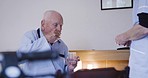 Nurse, help and senior man drinking pills for healthcare, hypertension or diabetes in a home. Retirement, nursing and sick elderly patient with water and medicine from a woman helping at home