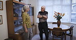 Love, retirement and conversation with a senior couple in the living room of their home chatting together. Security, trust and support with a mature man and woman talking while bonding in the house