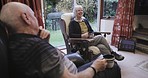Senior couple talking, living room and communication in a nursing home together with love. Marriage retirement and old man and woman sitting in a lounge with elderly communication and happiness