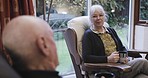 Senior woman, house and couple love in retirement with a smile and elderly care together. Living room, tea drink and happy discussion in a lounge sitting with happiness and loving conversation 