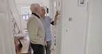 Retirement, thermostat and dial with a woman nurse showing a man patient the temperature control in his home. Assisted living, heating or switch with a female medicine professional and male resident