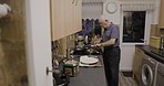 Elderly person, kitchen and organic cooking of a senior man with vegetables and eggs on a stove. Home, health food and diet recipe of a male in retirement with apron and ingredients at a house