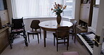 Disability, room or wheelchair in empty house, nursing home or dining furniture by table desk or piano keyboard. Chairs, help or retirement healthcare aid in property, real estate or wellness hospice