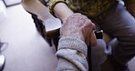 Hand holding, senior and patient in therapy for support, care and grief due to cancer in retirement home. Elderly, old and closeup of mature couple with trust or hope and walking stick as help