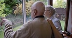 Retirement garden, talking and senior couple in house planning, investment or plants for backyard wellness. Real elderly people, nursing home and real estate woman, partner or people ideas at window