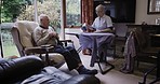 Morning, conversation and senior couple ironing, talking and in communication during housework. Laundry, company and elderly man speaking to a woman doing chores, housekeeping and housewife work