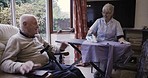 Smile, conversation and senior couple ironing, talking and in communication during housework. Laundry, company and elderly man speaking to a woman doing chores, housekeeping and housewife work