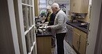 Elderly, couple is cooking together in retirement and food with lifestyle, wellness and nutrition with healthy meal. Help, love and care in marriage, old man and woman in kitchen, trust and retired