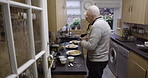Old couple cooking, retirement and food with nutrition, wellness lifestyle and nutrition with healthy meal. Help, love and care in marriage, elderly man and woman in kitchen, trust and retired people