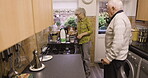 Coffee, conversation and retirement, couple in kitchen talking and help at breakfast time in home together. Morning chat, drink and old man disability, woman making tea, marriage with smile and love.