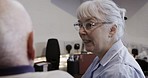 Computer, discussion and woman helping a man with online technology in his retirement home. Tech, internet and senior female talking and assisting a elderly guy with a phone for networking