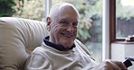 Face, old man and watching television to relax, smile and in nursing home for retirement, happiness and peace. Portrait, senior citizen and mature male with remote for tv, calm and joyful in lounge