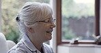 Happy, smile and senior woman talking in a discussion laughing in a retirement home or house. Face, head and elderly female in conversation with a positive mindset and happiness for communication