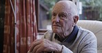 Dementia, thinking and senior man in a home with mental health, anxiety and sad in a chair. Idea, stress and elderly person with fear, lonely and missing family while depressed with alzheimer