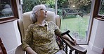 Thinking, retirement and senior woman in chair by window for relaxing, contemplation and thoughtful. Nursing home, memories nostalgia and sad elderly lady in living room for peace, quiet and calm
