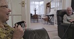 Elderly couple, home living room and coffee on sofa, conversation and relax together in retirement. Old woman, man and tea on lounge couch for comic, funny joke and speaking of life memory in house