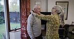 Senior couple, man and woman with help for dress up with clothes, homecare support and care in home. Elderly people, helping hand and shirt collar to start morning together for happiness in house