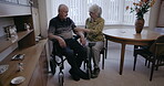 Hypertension, senior and couple with a healthcare machine, blood pressure monitor and medical exam. Care, rehabilitation and disabled elderly man with a woman reading information on health at home
