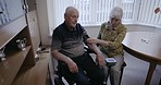 Hypertension, senior and couple with a healthcare check, blood pressure monitor and medical exam. Care, rehabilitation and disabled elderly man with a woman reading blood pressure information