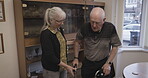 Caregiver, senior and man with walker in an old age retirement home disabled in a nursing house. Elderly, pensioner and nurse help mature male walk with care, support and healthcare in a lounge