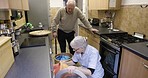 Kitchen, home and senior couple doing laundry together while spring cleaning and tidying their home. Housework, chores and elderly man and woman in retirement washing clothes in house or apartment.