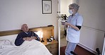 Nurse, bedroom and morning tea with an elderly man with a caregiver in a nursing and retirement home. Rehabilitation, therapist and healthcare of a old male at a clinic or hospital with help