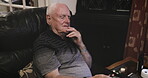 Senior man, sofa and watching tv thinking with remote for changing channels, entertainment or movie at home. Elderly male in retirement streaming online relaxing in living room on soft couch or chair