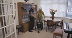 Senior couple, disability support and love with old man helping wife with a walker. Trust, marriage care and nursing home with elderly people together in retirement house and living room lounge