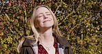 Woman, travel and face smile for nature, fresh air or sunshine getting vitamin D by countryside. Happy female traveler smiling in joyful happiness for calm relaxation, freedom or natural environment