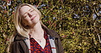 Happy woman, travel and smile for nature, fresh air or sunshine getting vitamin D by countryside. Female traveler smiling in joyful happiness and relaxation for calm, freedom or natural environment
