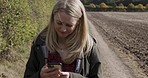 Peace, woman and walking countryside, smartphone and relax on summer vacation, fresh air and calm. Female, lady and outdoor with cellphone, social media and connection in nature and on weekend break