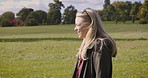 Happy, nature and woman on a walk in a field for outdoor fresh air, exercise or alone time. Happiness, smile and mature female walking in a green garden for wellness or health in summer in Canada.