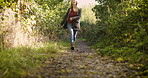 Woman, walking and celebrating freedom in nature for travel, trip or adventure in the countryside. Happy blond female enjoying walk and twirling in joyful happiness for natural environment outdoors