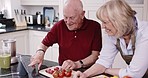 Online recipe, tablet and retirement, happy couple in kitchen, cooking lunch with healthy food and vegetable diet. Old woman, senior man and internet search for meal prep, marriage bonding in home