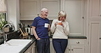 Happy, talking and senior couple drinking coffee, funny and bonding in the kitchen in the morning. Laughing, calm and an elderly man and woman speaking with a cup of tea together in their home