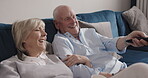 Relax, laugh and happy elderly couple watching tv, funny subscription video or streaming home media channel. Remote control, quality bonding time and senior people laughing at with television program