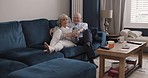 Conversation, phone and relax elderly couple hug, talking and in living room discussion about online shopping. Marriage love, mobile smartphone or happy man, woman or home people scroll on website