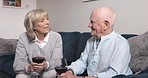Love, red wine or senior couple on a couch, bonding or romance with quality time, anniversary or relationship. Partners, elderly man or mature woman at home, alcohol, loving or romantic in the lounge