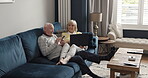 Phone, laptop and senior couple talking about online technology, living room conversation or home retirement discussion. Communication, love and relax old people speaking about digital news article
