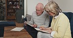Senior couple, budget and finance documents in home for insurance payment, notes and investment. Old man, woman and paperwork of retirement savings, pension planning and discussion for drafting will
