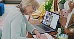 Senior woman, laptop and writing in book for planning or idea strategy in creative design and remote work. Elderly female person, freelancer or designer taking notes for schedule plan working at home