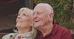 Senior couple, park bench and laughing with marriage, love and retirement outdoor. Vacation, relax and smile of elderly people in a garden on a date together with care and support with funny joke