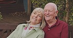 Senior couple, park bench and laugh with marriage, love and retirement outdoor. Vacation, relax and smile of elderly people in a garden on a date together with care and support with hug and joke