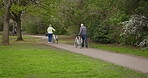 Health, senior couple and riding bicycle for exercise, fitness and wellness being healthy together in nature. Retirement, man and woman enjoy bike ride in a park or garden