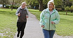 Health, senior couple and running for exercise, fitness and wellness being healthy together in nature. Retirement, man and woman enjoy workout and jog in a park or garden