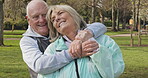 Happy senior couple outdoor and in love, spending quality time together in nature. Retirement and man and woman enjoy a relax day in a park or garden