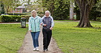 Health, senior couple and walking for exercise, fitness and wellness being healthy together in nature. Retirement, man and woman enjoy workout in a park or garden