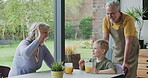 Grandparents, high five and grandson talking with orange juice together in the kitchen with support at home. Love, support and motivation with discussion and family advice