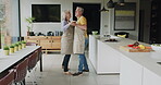 Senior couple, dance in kitchen and smile with love while making breakfast in their home. Happy old man, dancing with smiling elderly woman and fun in retirement together while cooking